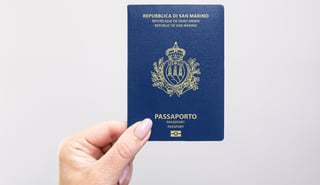 Hand holding a San Marino passport