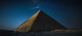Pyramid under a starry night sky
