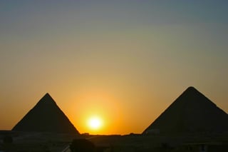Sunset behind pyramids of Giza Egypt