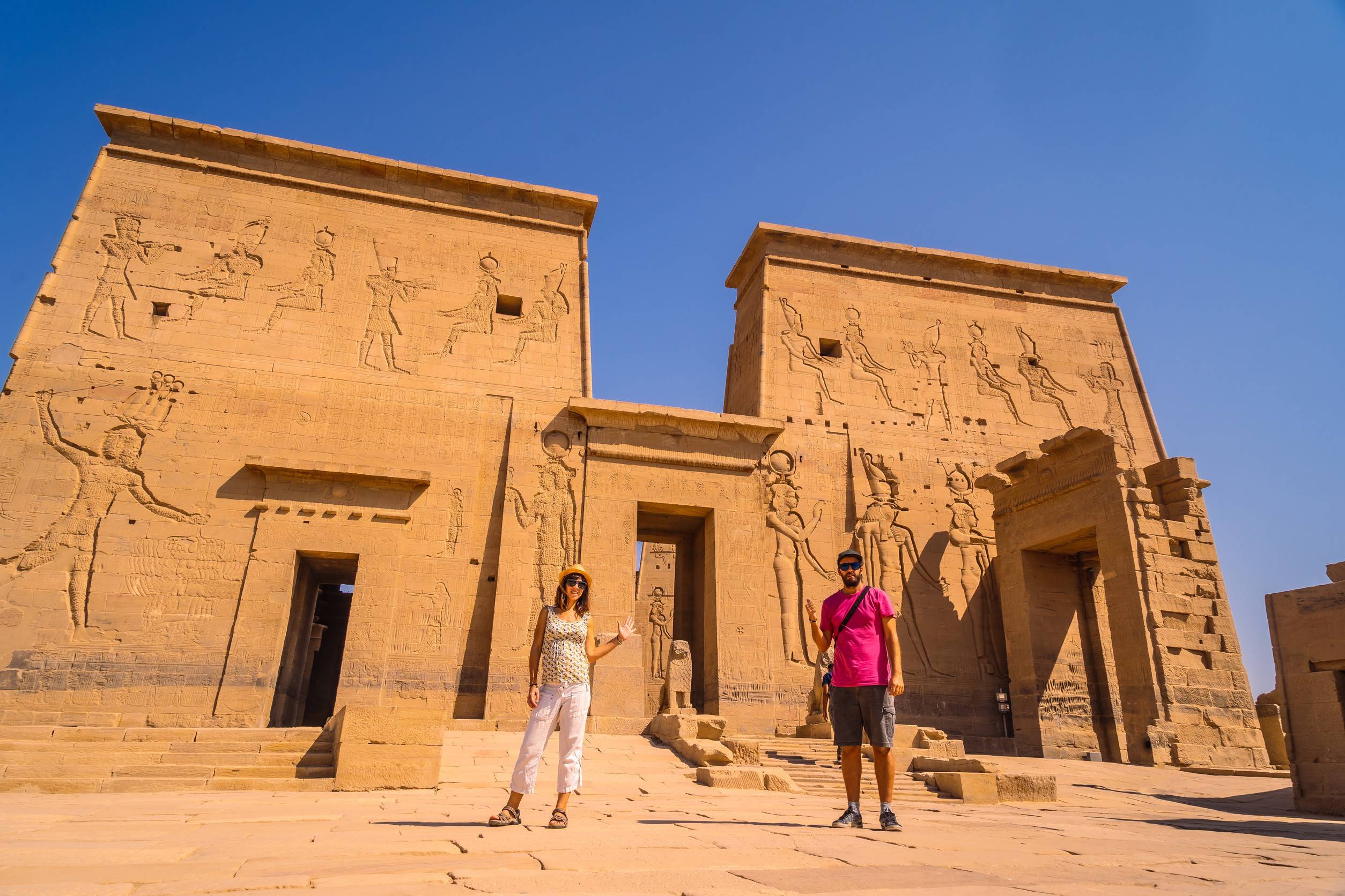 A Couple Of Tourists At The Temple Of Philae A Greco Roman Construction Seen From The Nile River
