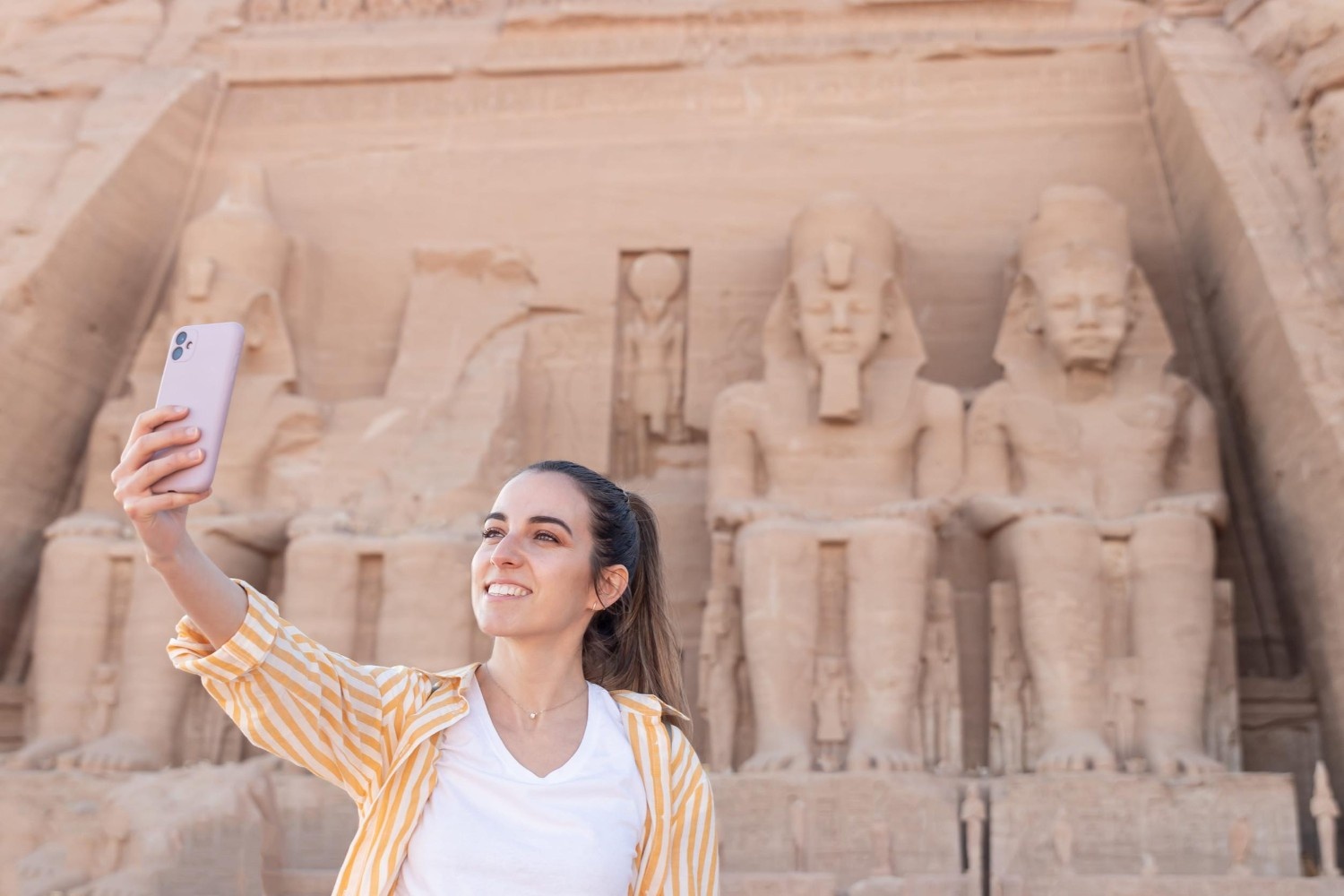 A Woman Taking A Selfie In Nefertari Ancient Temple In Abu Simbel A Woman Taking A Selfie In Nefertari Ancient Temple In Abu Simbel