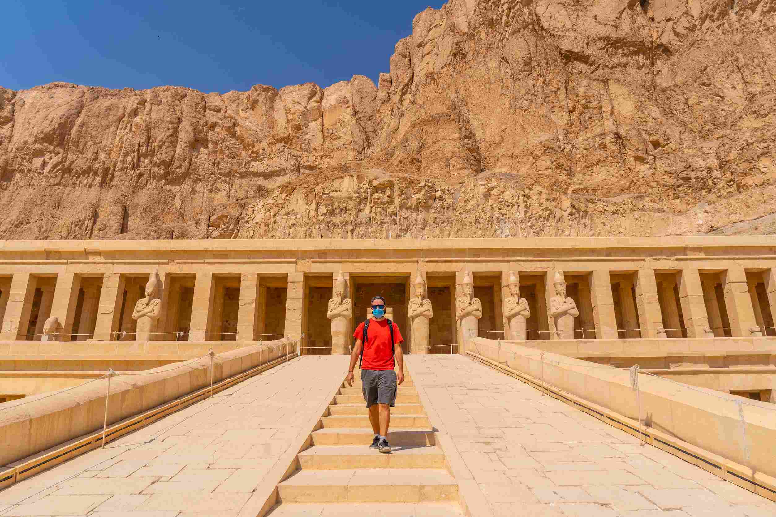 https egypt eta com images a young man with a face mask visiting the mortuary temple of hatshepsut in luxor after