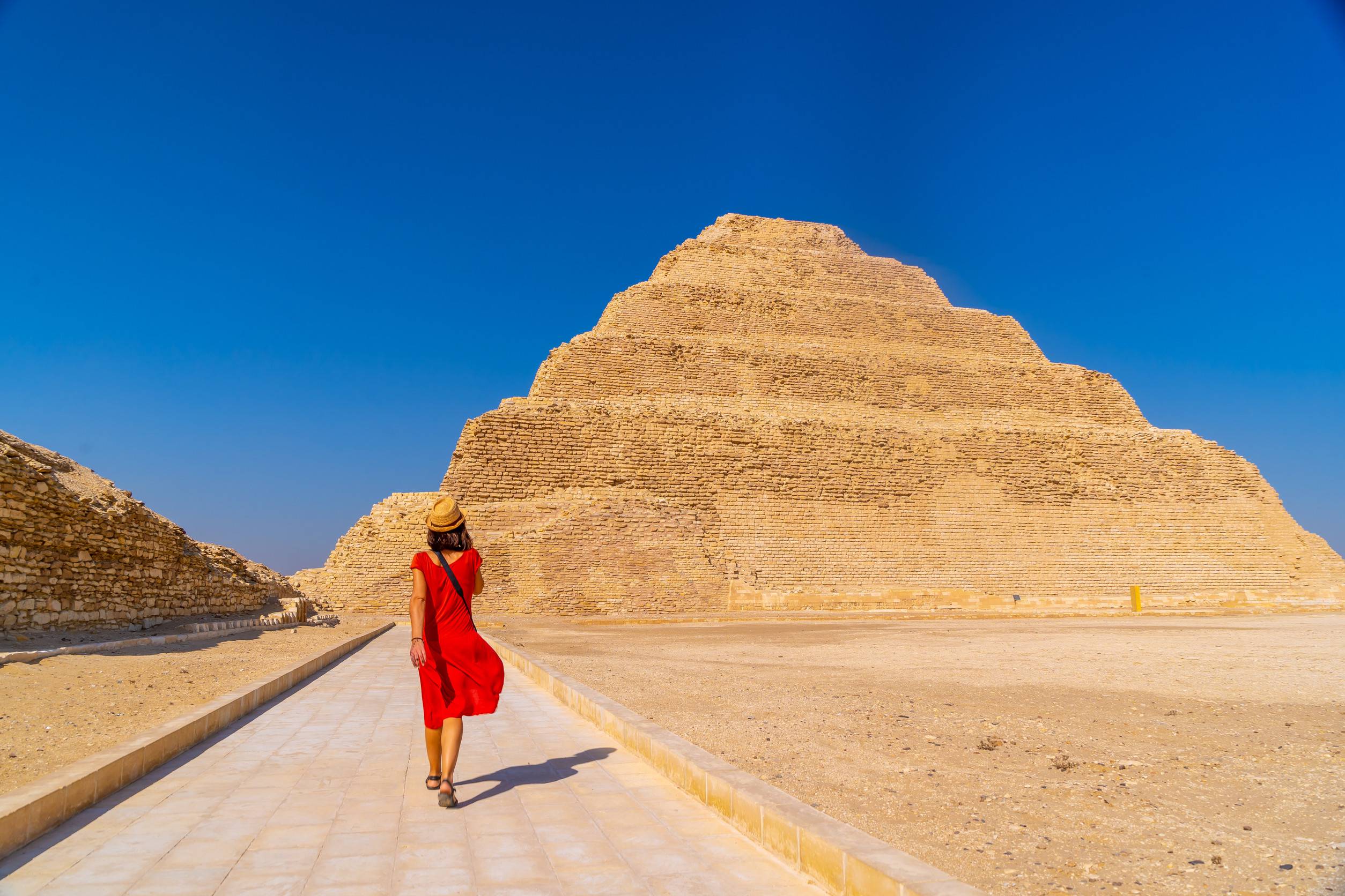 https egypt eta com images a young tourist in a red dress at the stepped pyramid of djoser saqqara egypt the most important
