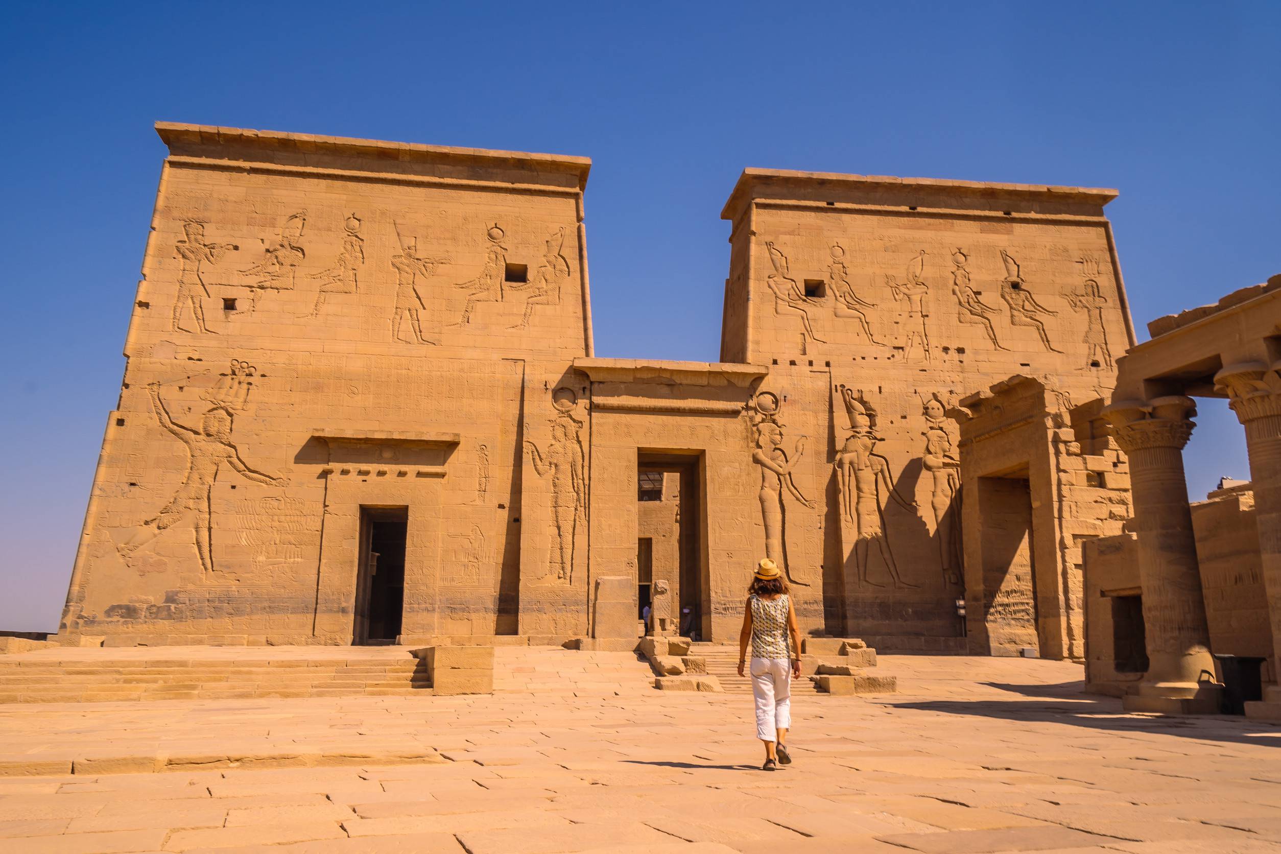 https egypt eta com images a young tourist visiting the temple of philae a greco roman construction seen from the nile riv