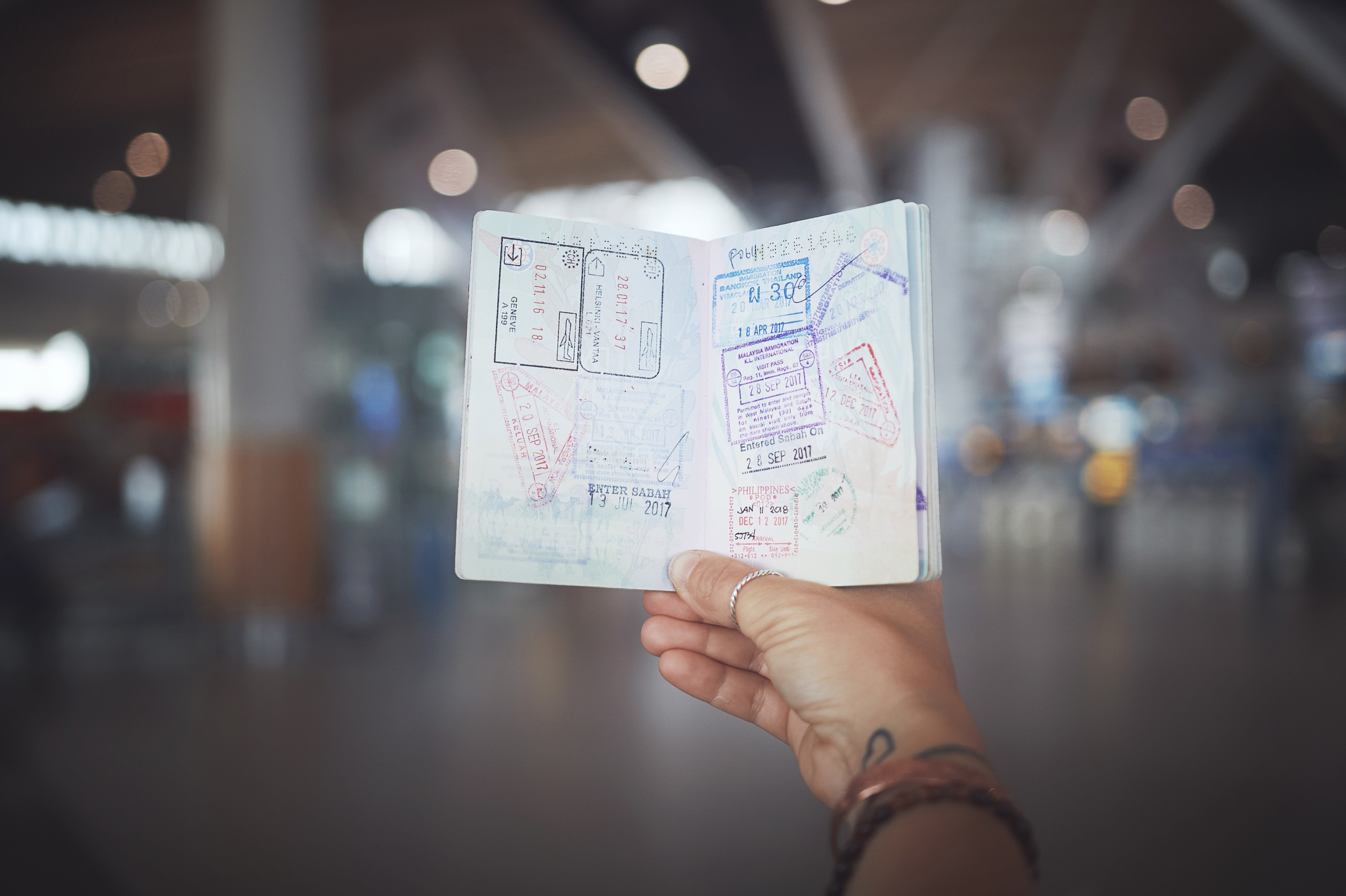 Catching Flights Not Feelings A Woman Showing Her Passport Stamps At The Airport
