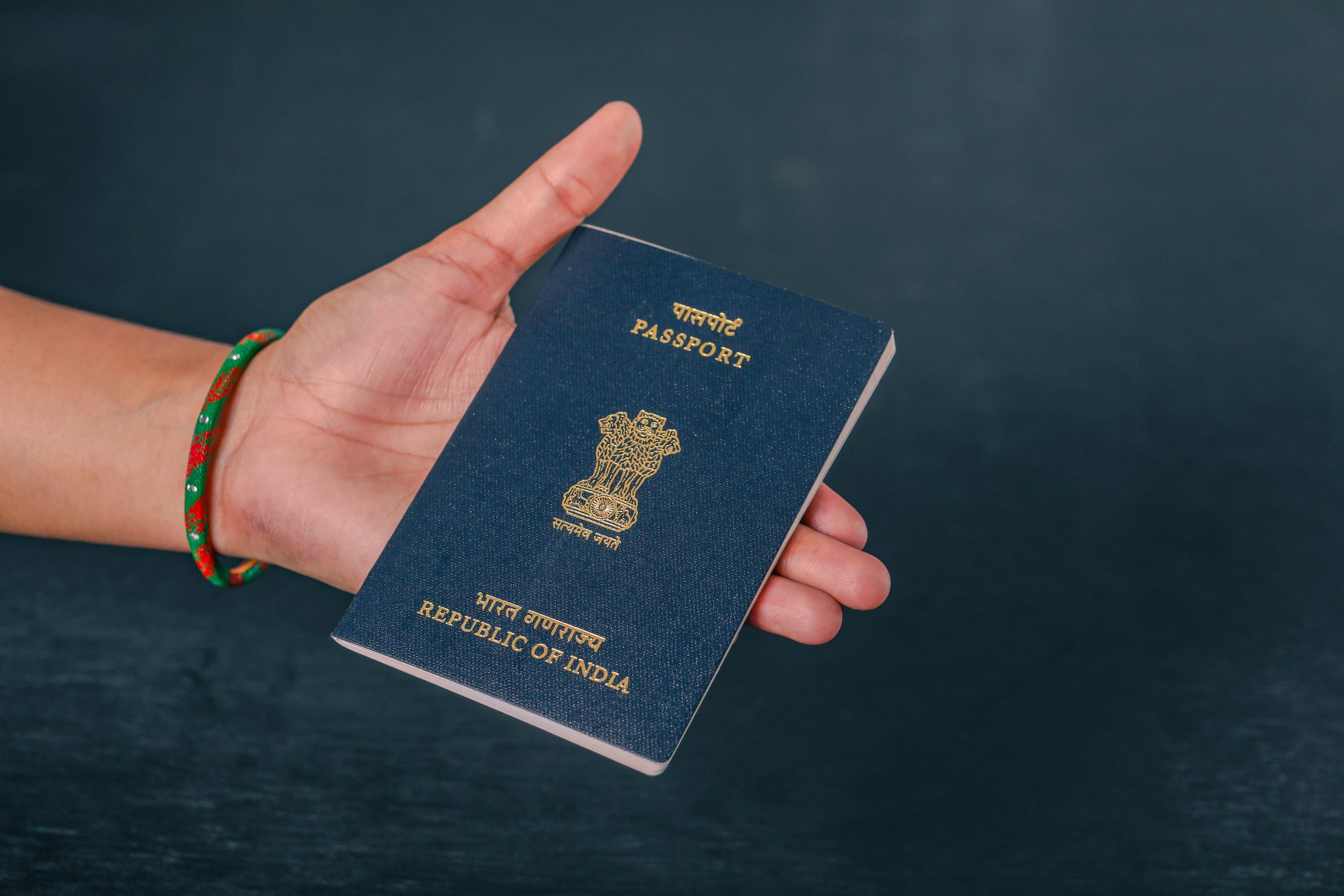 Hand holding Indian passport