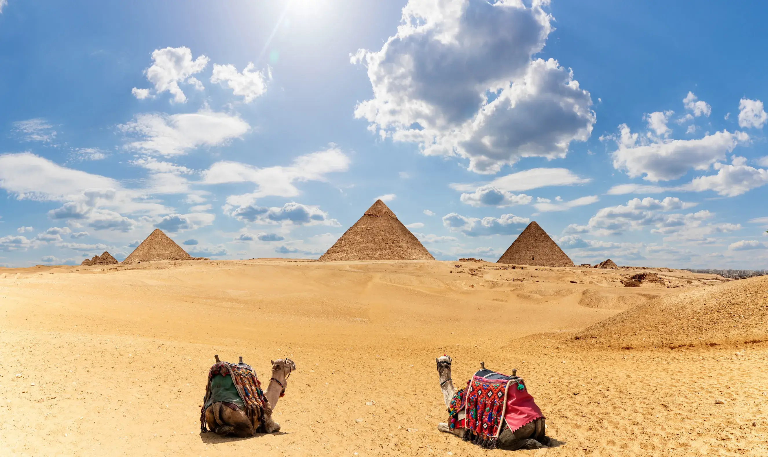 https egypt eta com images egypt pyramids panorama shot with two camels under the clouds with blue sky