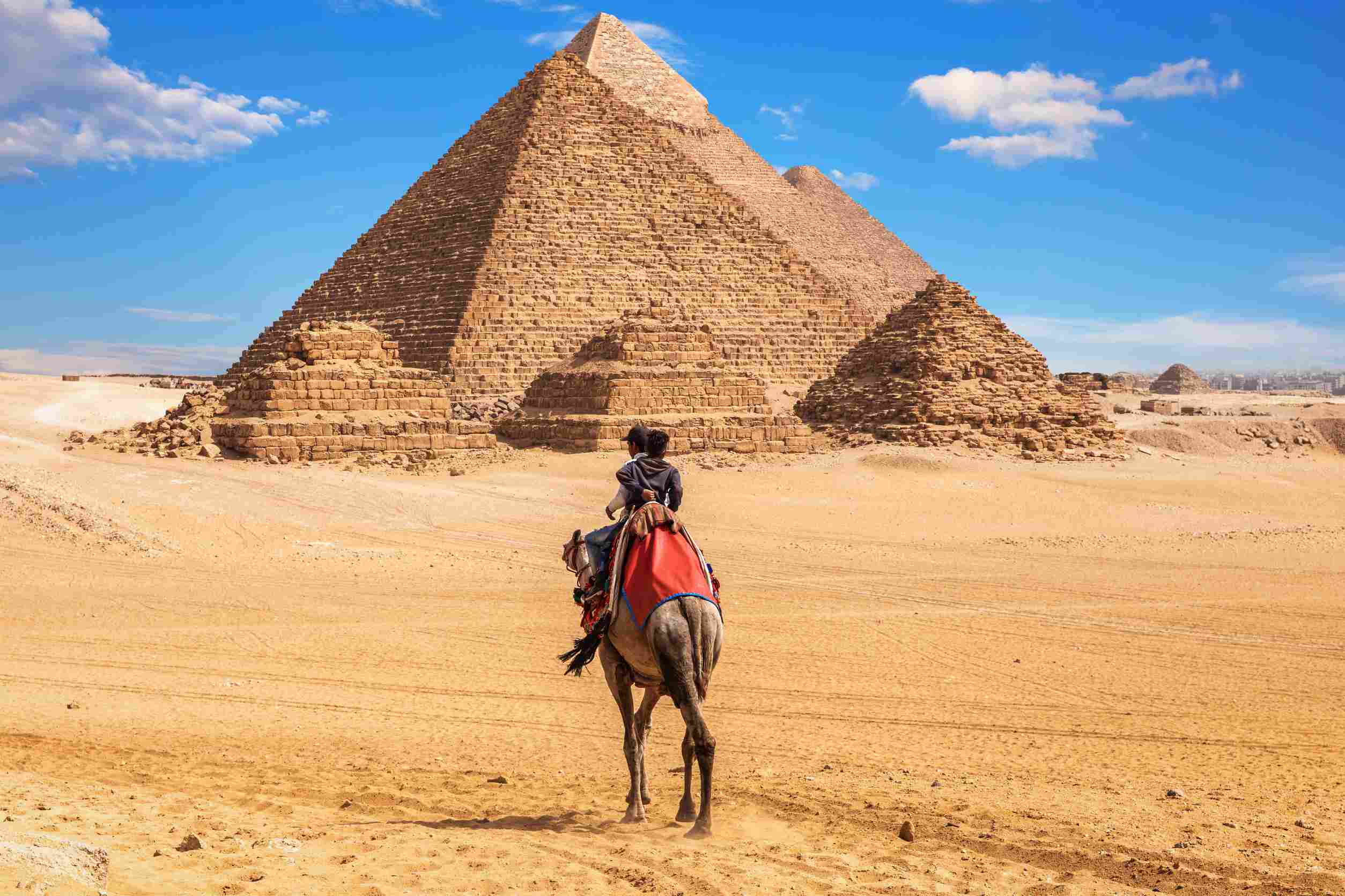 https egypt eta com images egyptians on camels near the complex of giza pyramids egypt