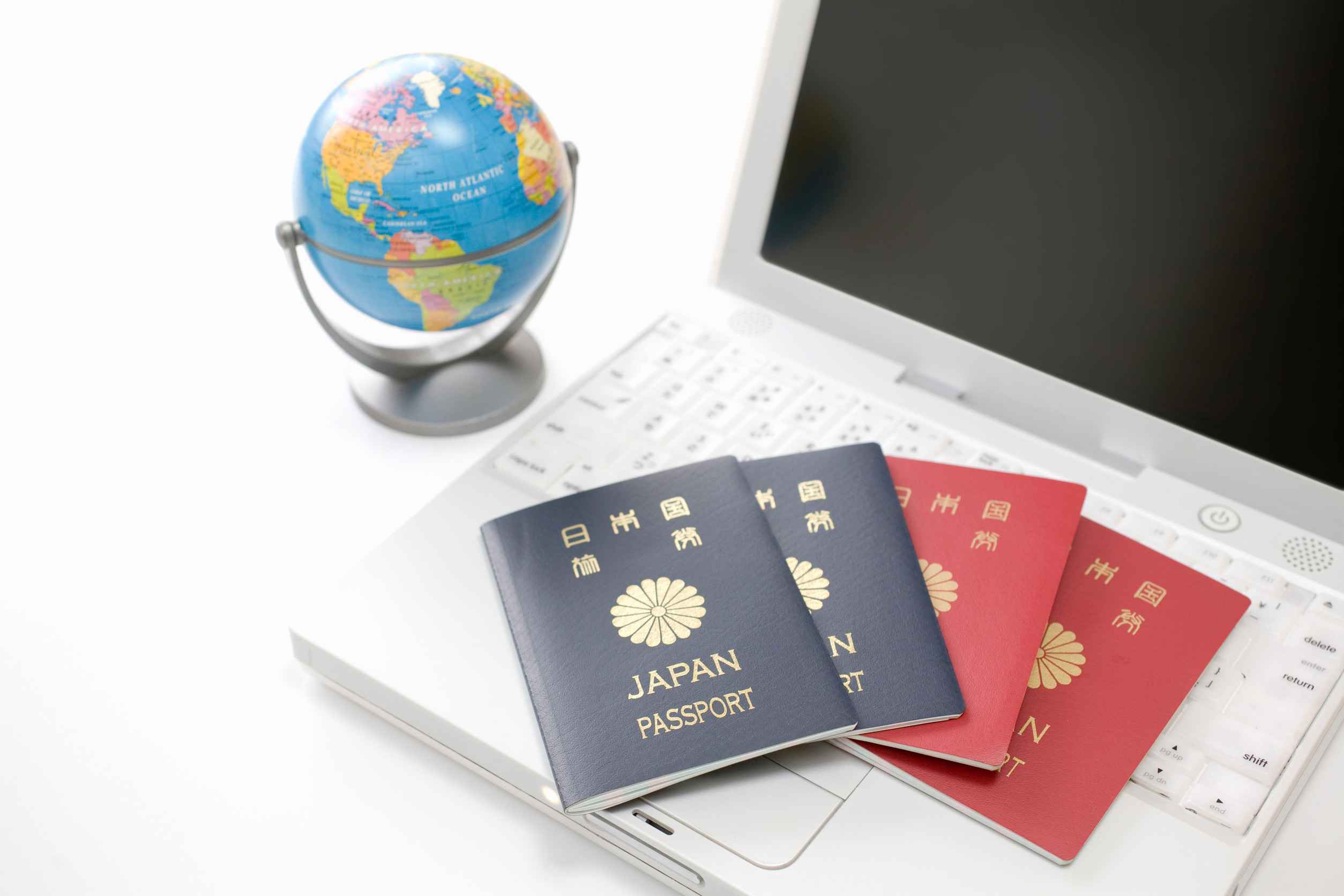  Japanese passports with globe and laptop