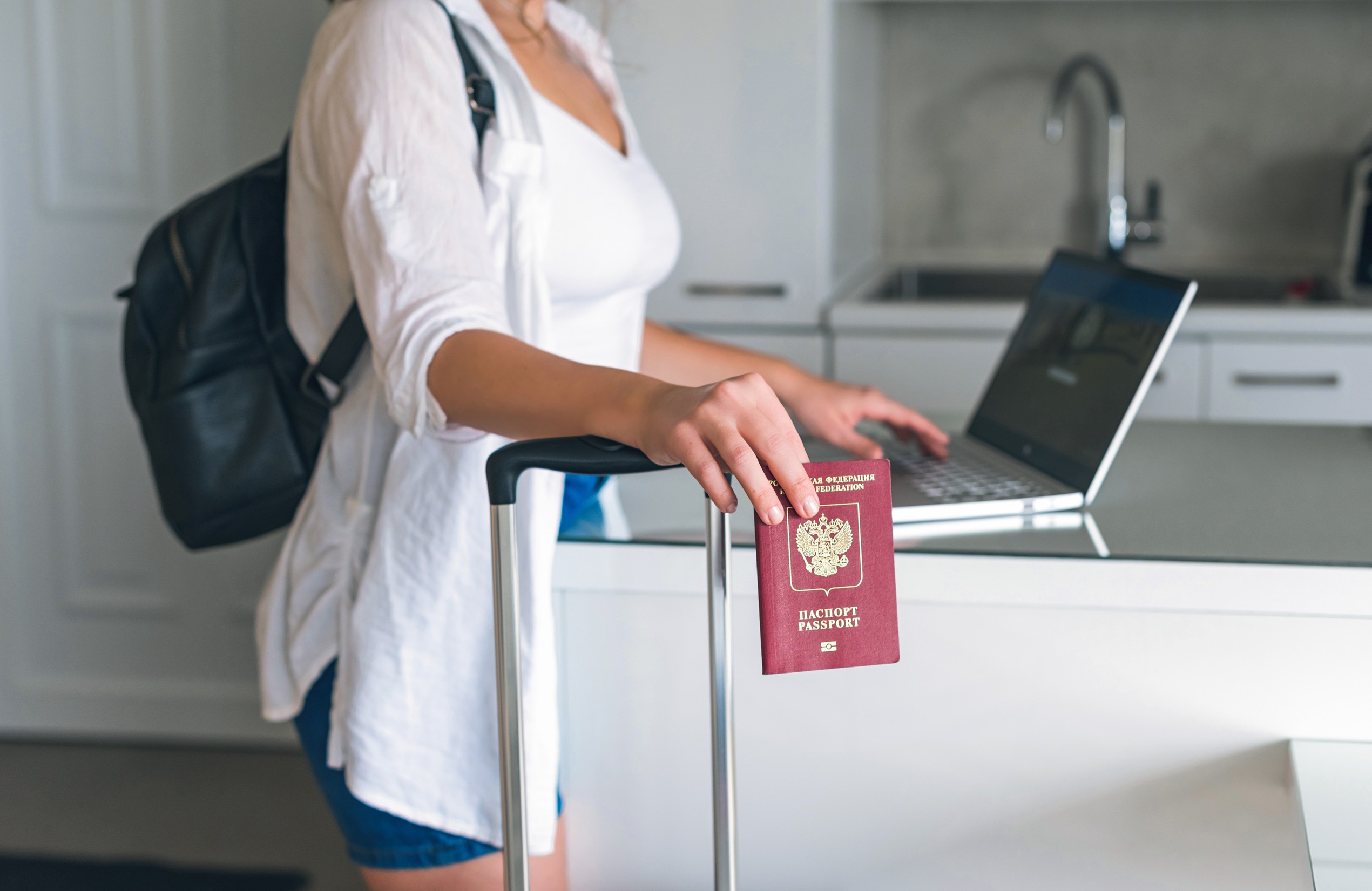 Online Check In With Laptop At Home Before Travel Female Checking In To Flight Standing