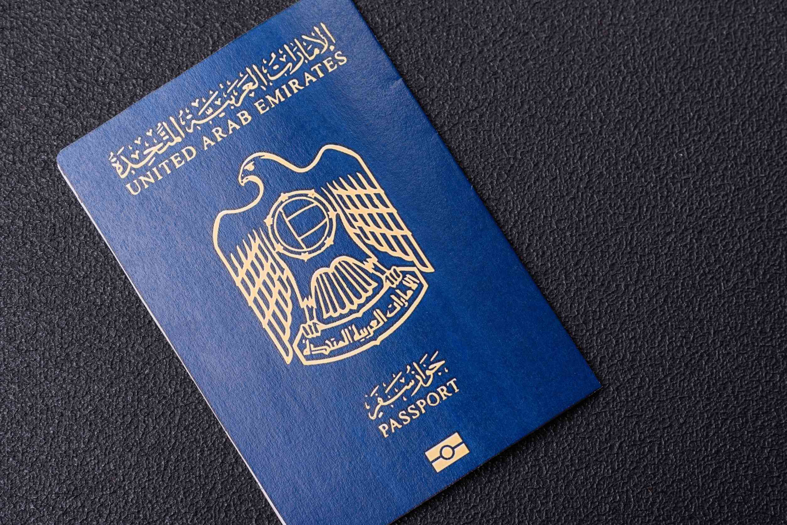 Physical Paper International Passport Of A Citizen Of The United Arab Emirates On A Dark