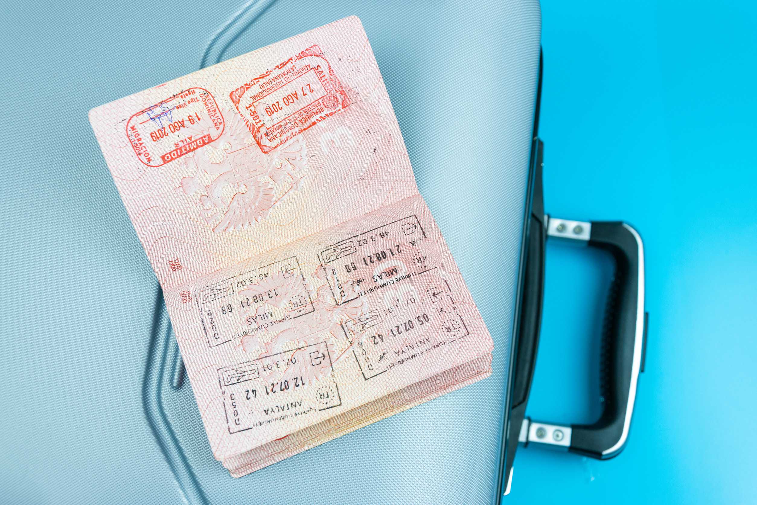 Raveler S Suitcase Is A Passport With Money And Credit Cards On A Blue Background The Concep