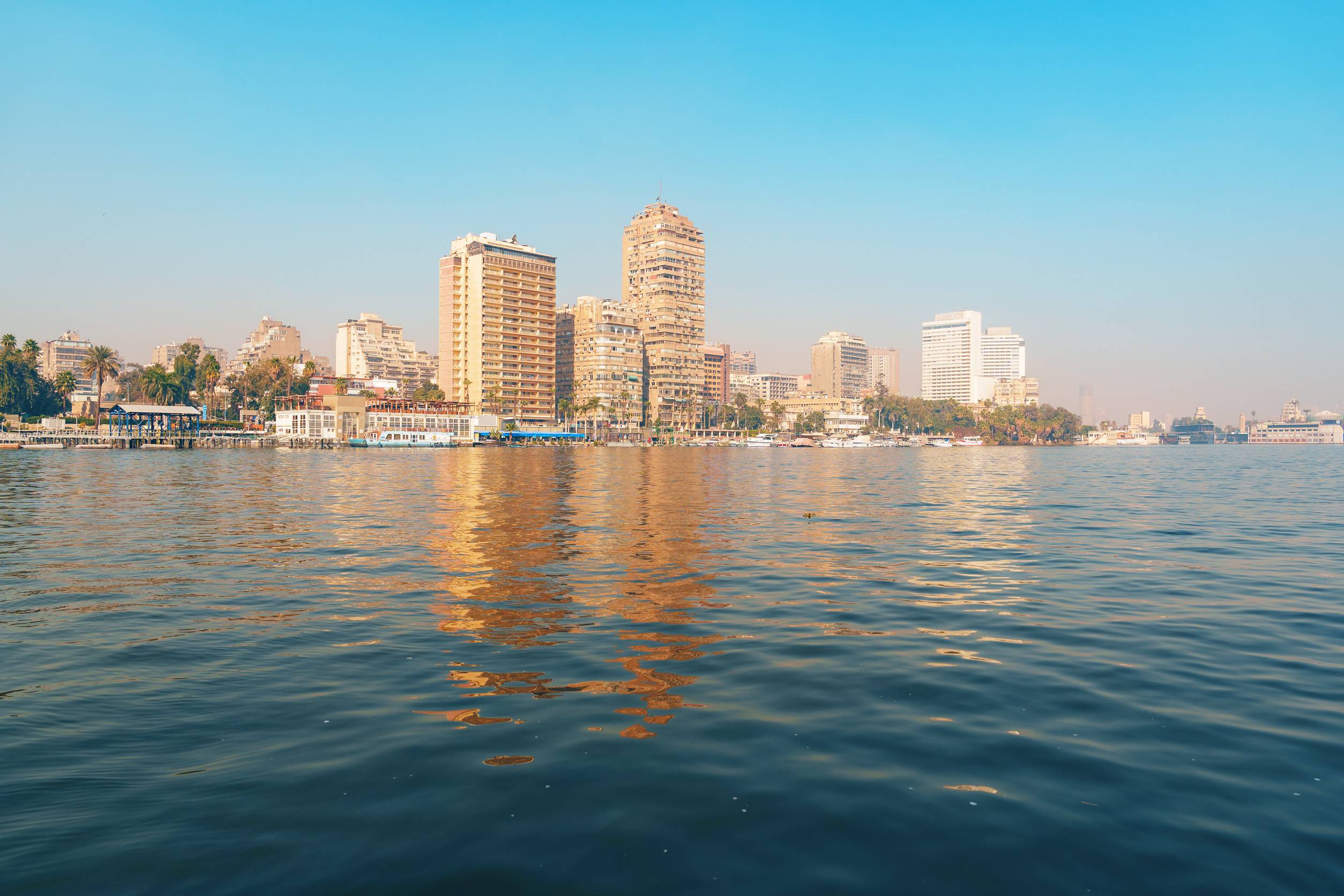 https egypt eta com images stunning skyline view of cairo with blue waters reflecting towering buildings on a clear sunny