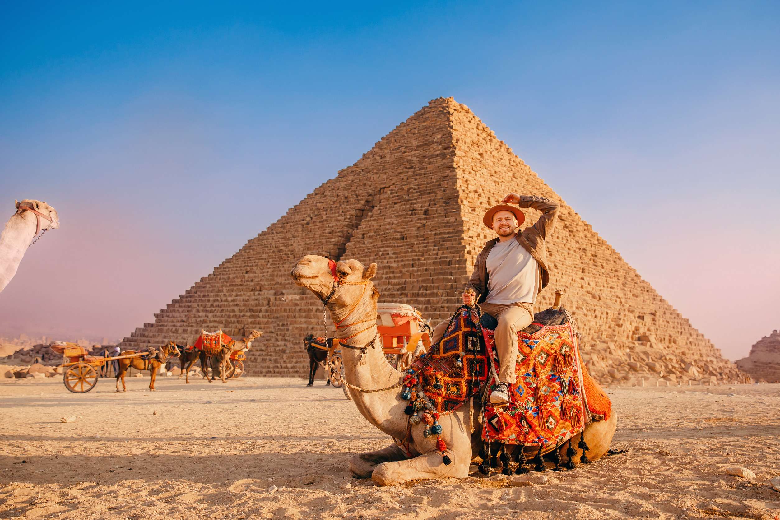Tourist Man With Hat Riding On Camel Background Pyramid Of Egyptian Giza Sunset Cairo Egypt