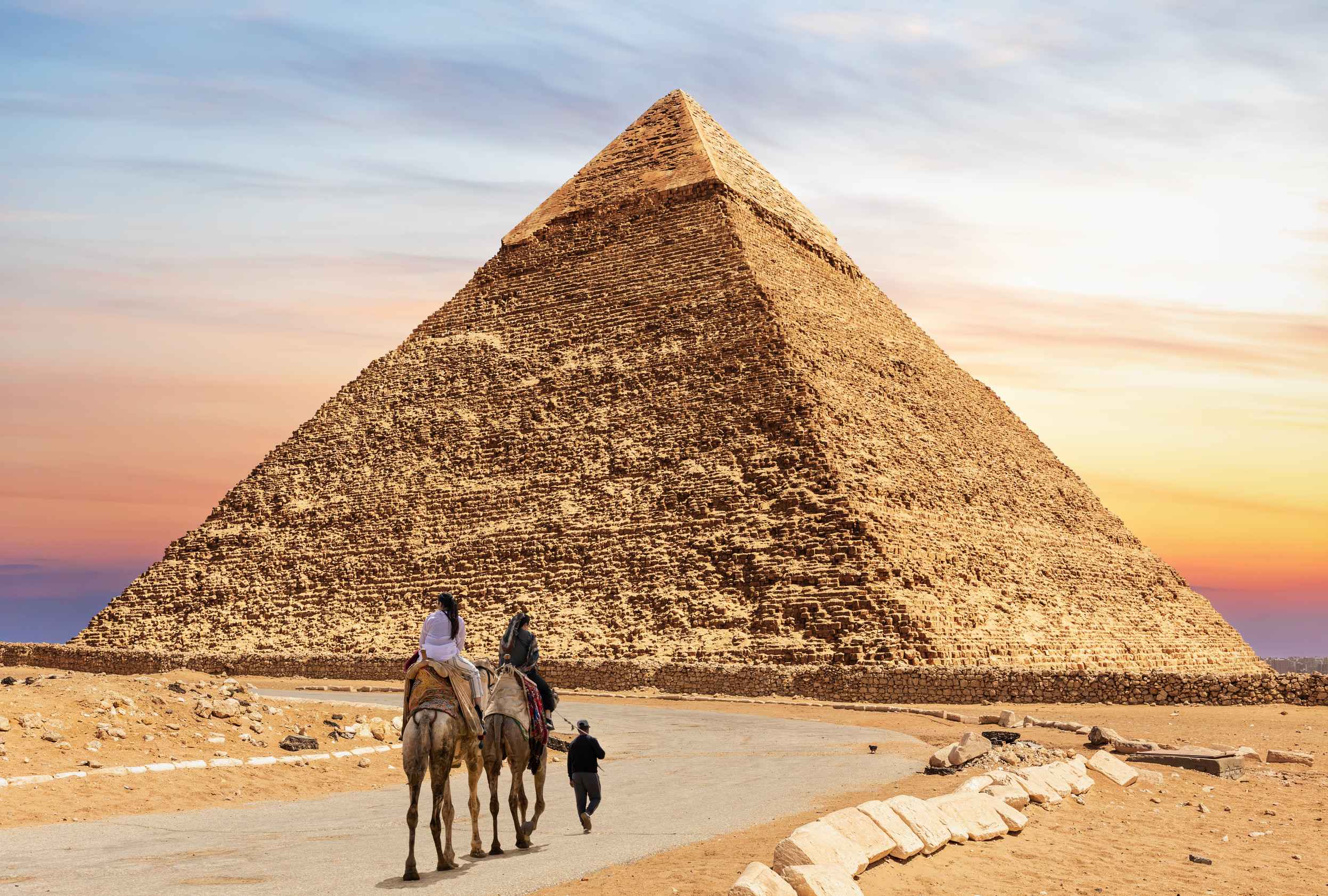 Tourists On Camels With Bedouin Near The Pyramid Of Chephren Egypt