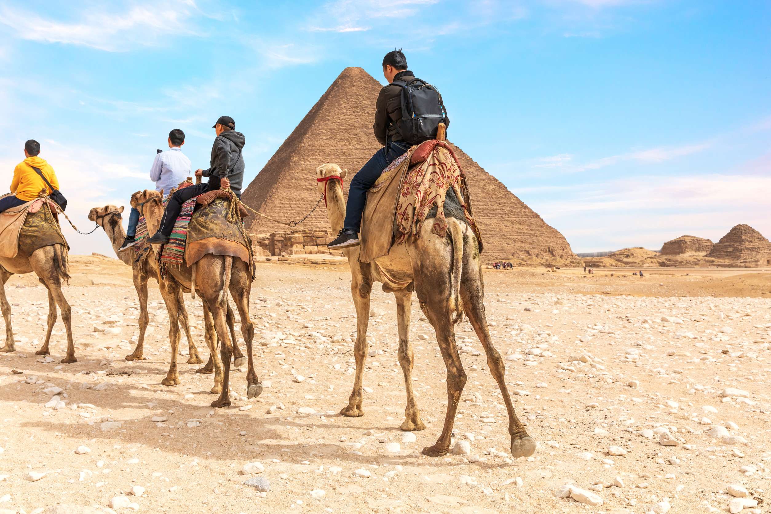 Tourists Riding Camels At Giza Pyramids