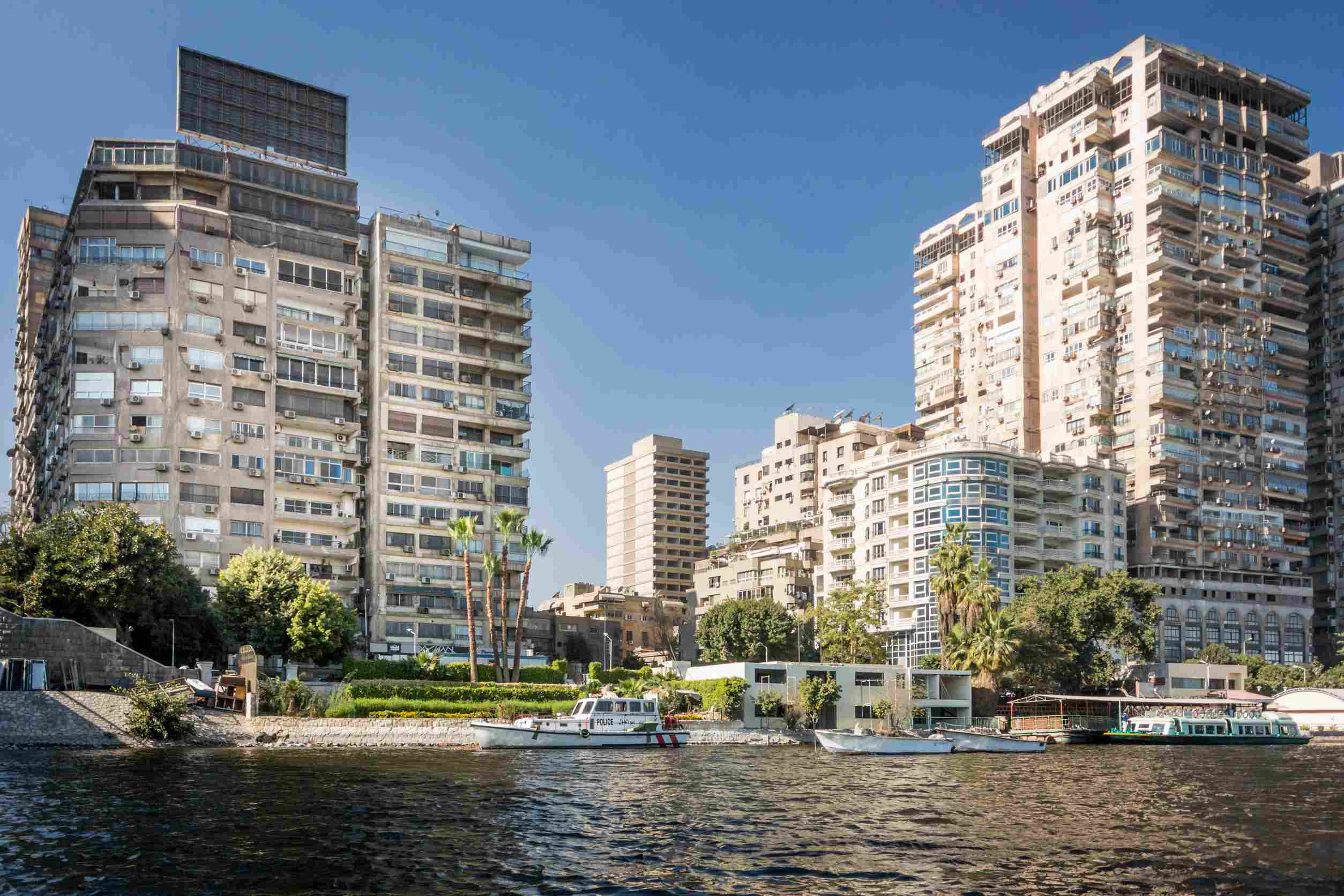 https egypt eta com images tower blocks on the banks of the river nile with boats in the foreground in the city of c