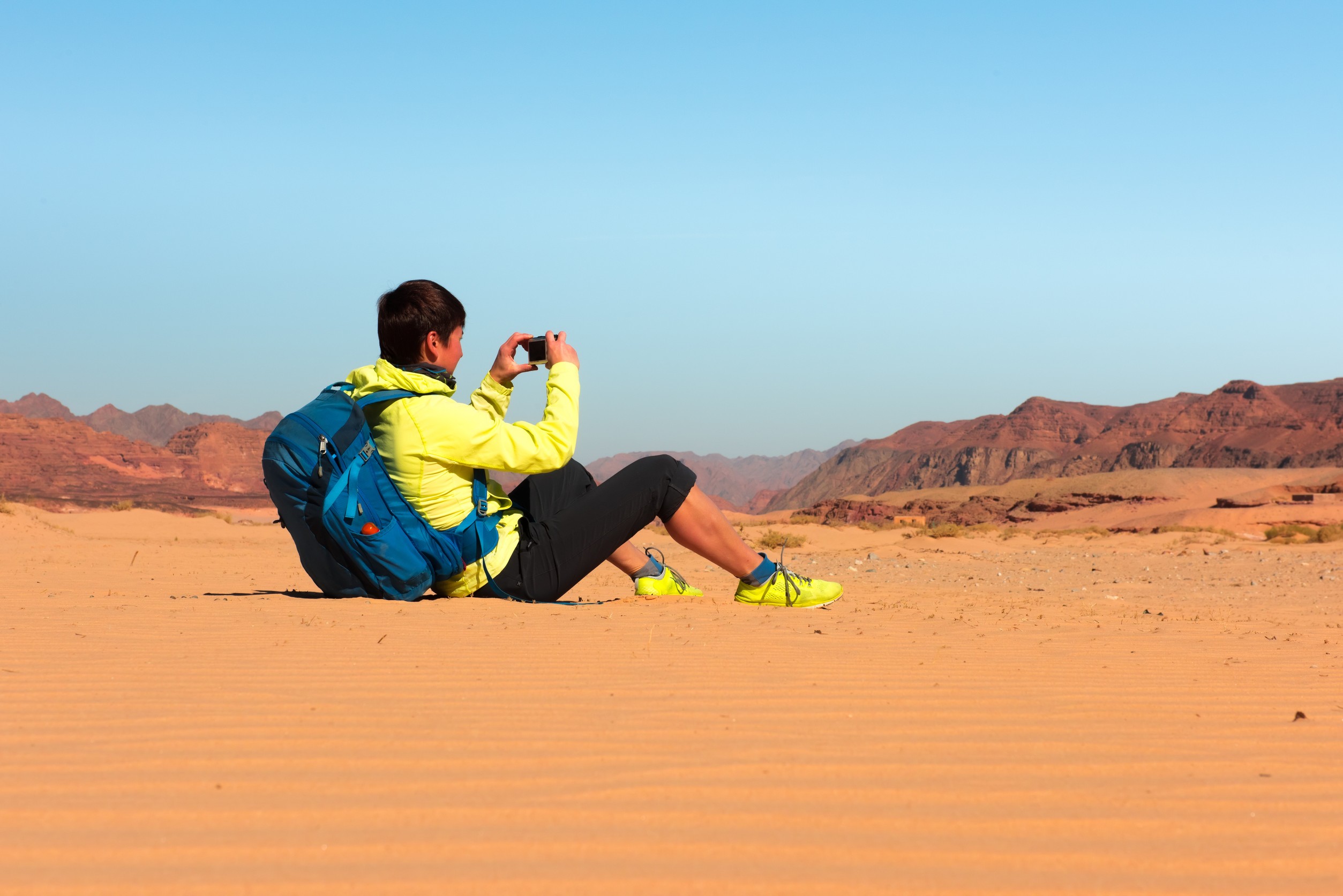 Woman Mountain Hiker With Backpack Makes Photo In Sinai Desert