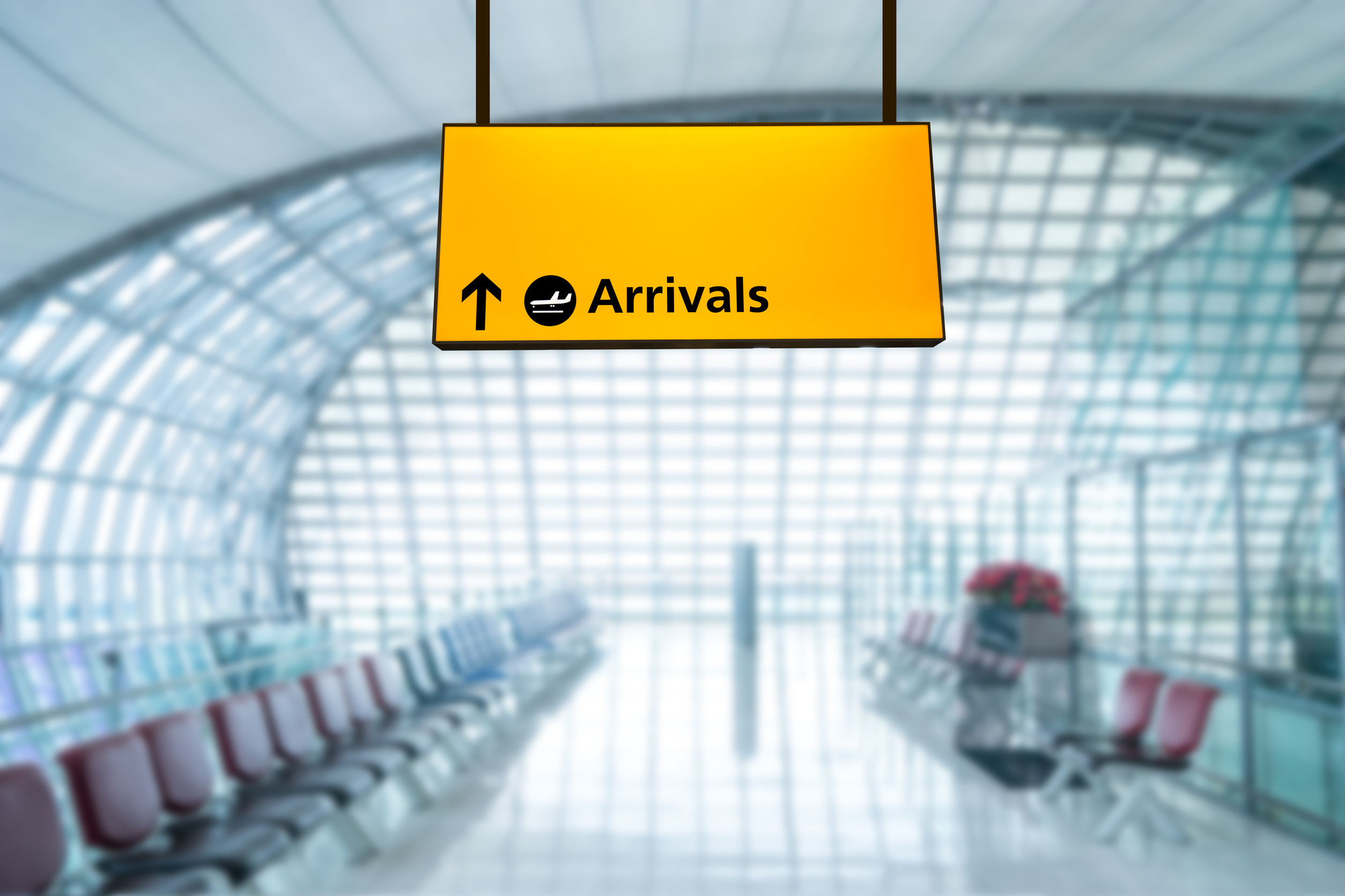 Yellow airport arrivals sign in terminal